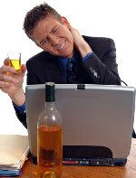 Photo of man looking stressed and drinking alcohol
