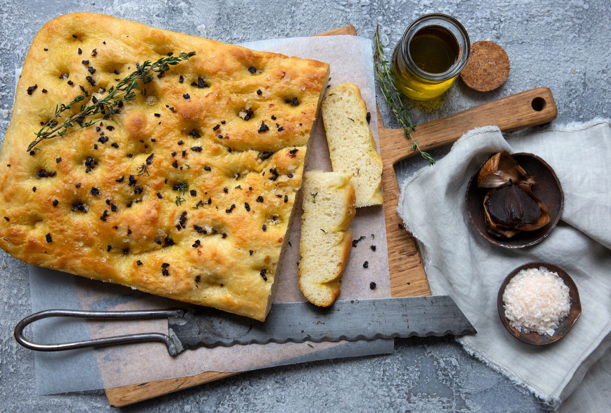 Golden focaccia with black garlic, smoked sea salt and rosemary botanical pattern