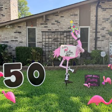 Pink flamingo decorations celebrate a 50th birthday.