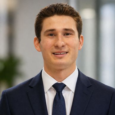 Professional young man in a suit smiling.