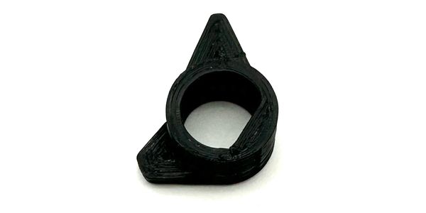 Black oddly shaped plastic ring.