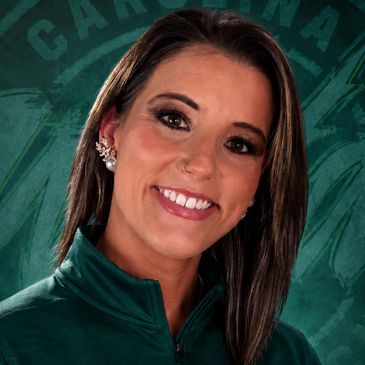 Portrait of a smiling woman with Carolina Wild logo background.