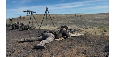Soldier lying prone aiming rifle during training.