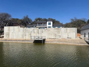 Front view of retainer wall between house and lake.