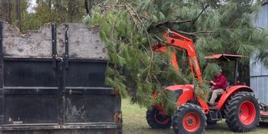 Kubota Tractor loading debris in dumpster