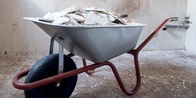 demolition services and debris haul off in wheelbarrow