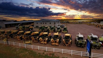 tractors parked in a row on the field 