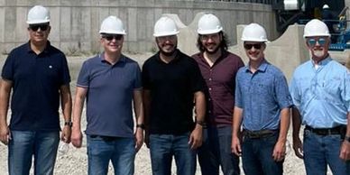 a group of men wearing safety helmets 