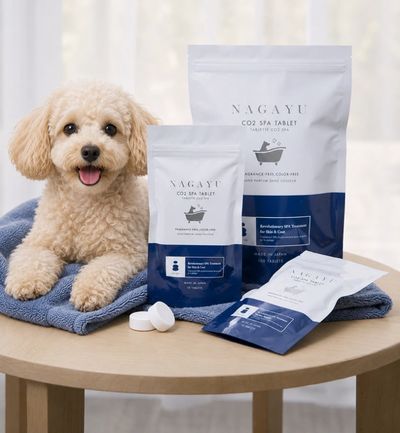 A fluffy dog with CO2 spa tablets for bath care on a table.