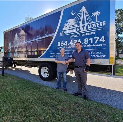 Two men shake hands in front of an Affordable Movers truck on a sunny day.