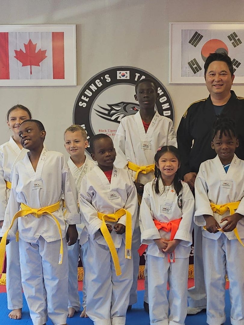 Group of Taekwondo kids with Master Seung smiling