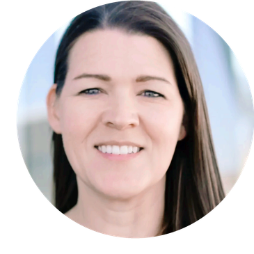 Portrait photo of a smiling white female with green eyes and straight brown hair