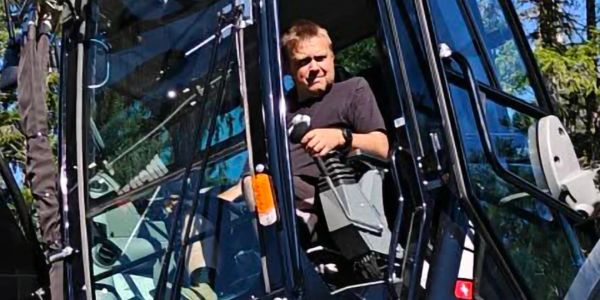 A man operating heavy machinery outdoors.