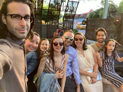 Group of friends enjoying an outdoor gathering on a sunny day.