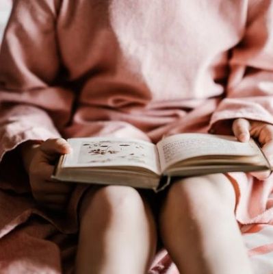 child reading a may justus book