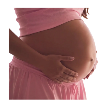 Pregnant woman gently holding her belly in pink attire.