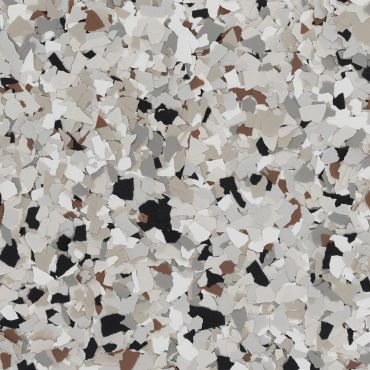 Close-up of a multicolored terrazzo floor with white, black, brown, and beige chips.