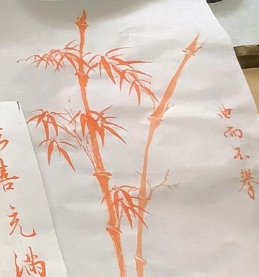 Traditional orange ink painting of bamboo on white paper with Chinese calligraphy.