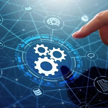 Finger pointing at digital gears icon on virtual interface.