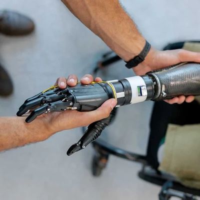 Person holding a modern robotic prosthetic arm.