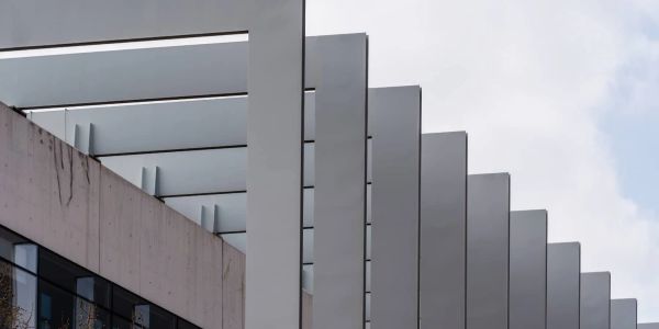 Modern architectural design with repeating vertical beams on a building.