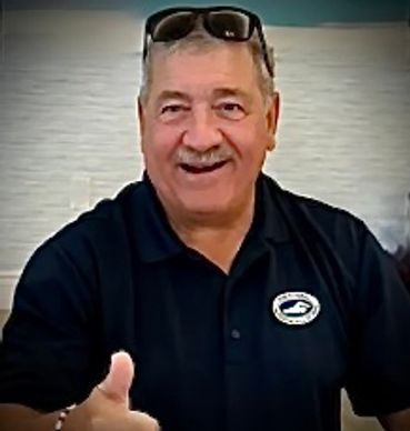Man giving a thumbs-up with sunglasses on his head.