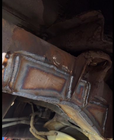 Close-up of a metal structure with fresh welding and discoloration.