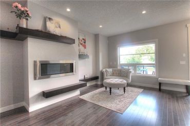 Modern living room with minimalist decor and large window.