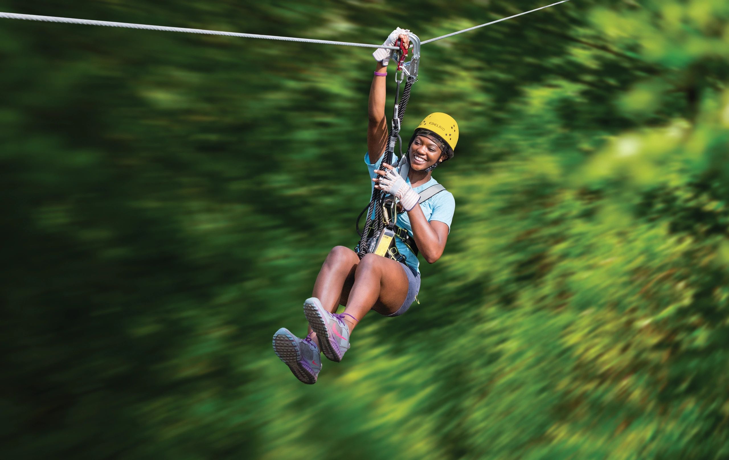 Zip-line participant at aerial adventure park in Ohio.