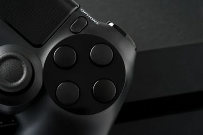 Close-up of black game controller buttons.