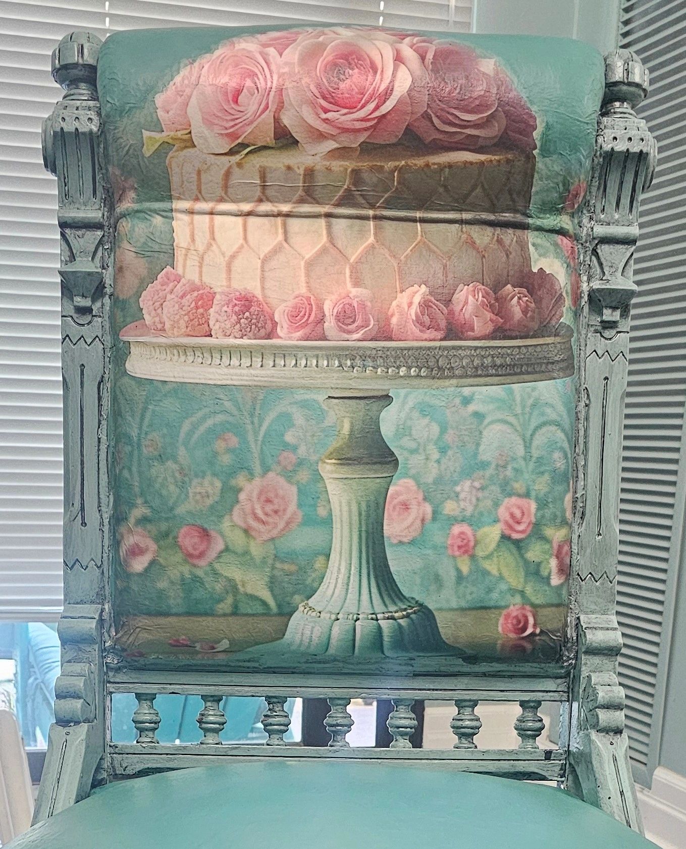 Antique chair with floral cake and rose design upholstery.