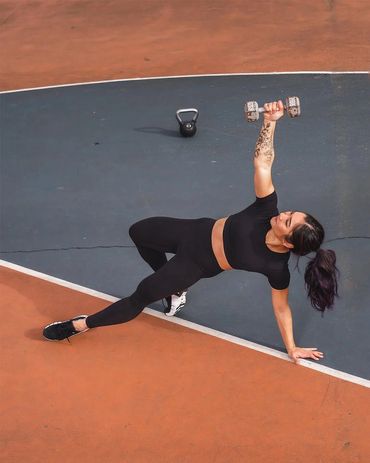 female fitness athlete performing functional exercise on pastel basketball court