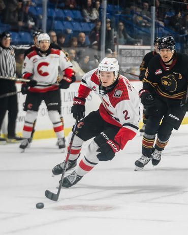 whl prince george cougars player skating after the puck in the vancouver giants arena