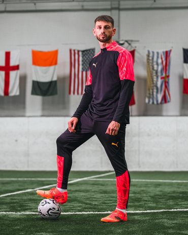 vancouver whitecaps player tristan blackmon posing with a soccer ball for a puma photoshoot