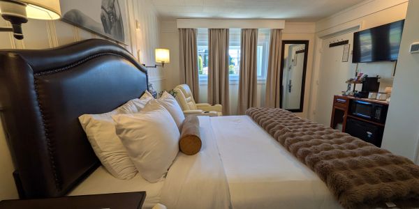 Cozy hotel room with a large bed and soft lighting.