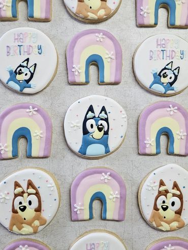 Colorful birthday cookies featuring cartoon dogs and rainbows.