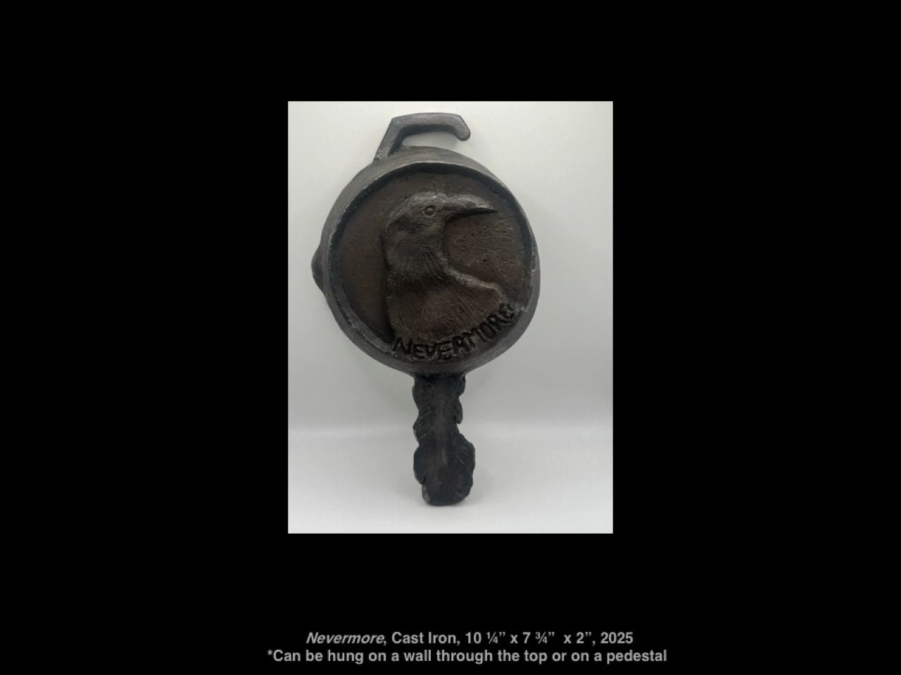 Cast iron artwork featuring a raven and the word 'Nevermore'