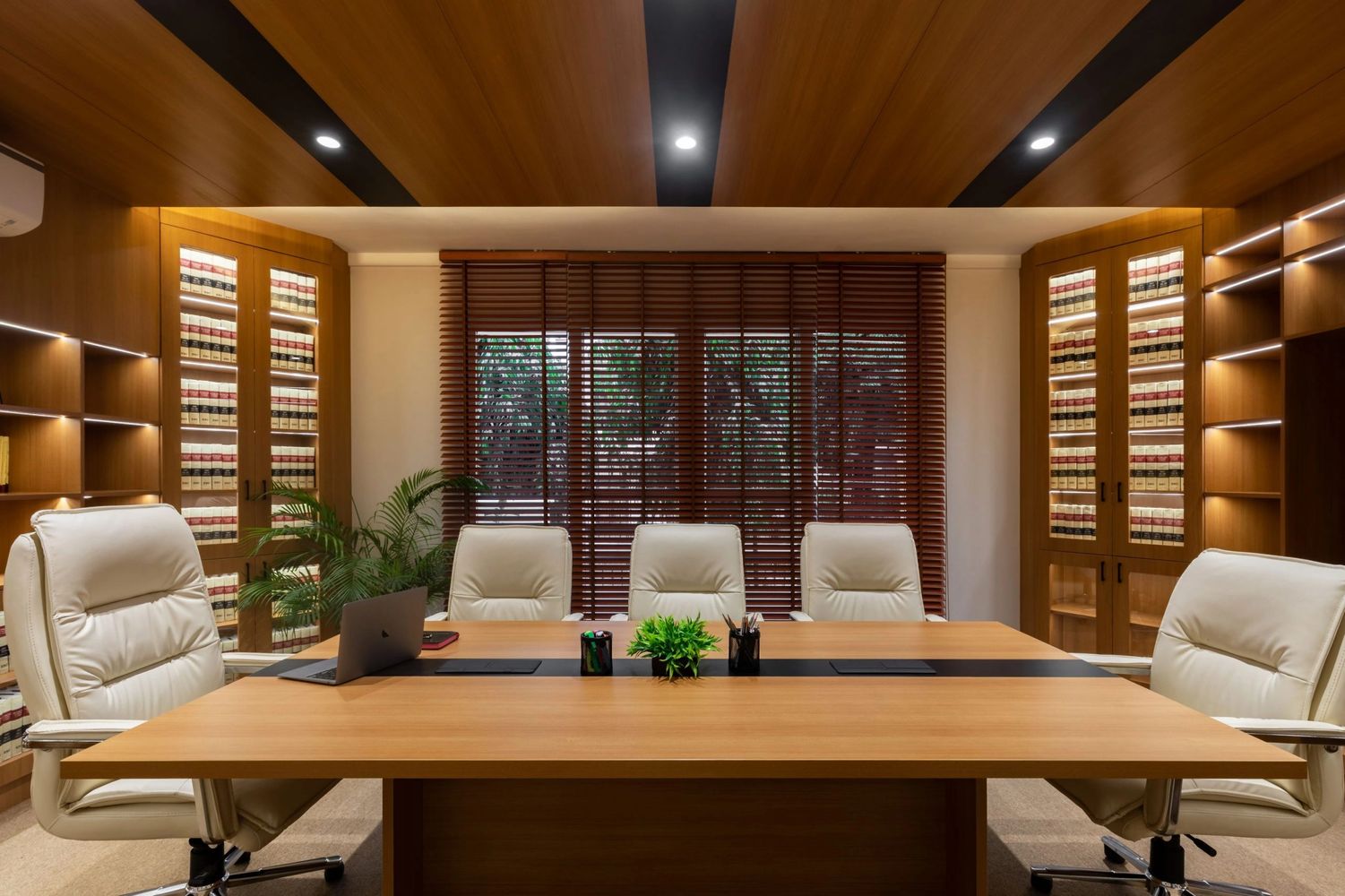 Modern office with wooden furniture and cream chairs.