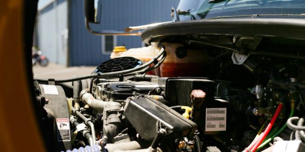 Close-up of a truck engine with various components visible.