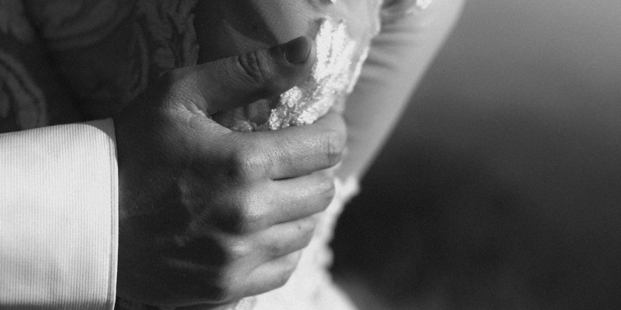 Grooms hand on the arm of the bride, very close-up, Intiem Weddings, image by Wouter Kleynhans