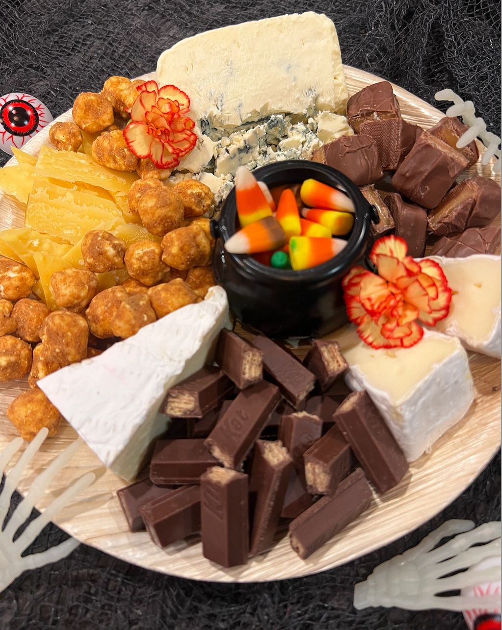 cheese and halloween candy paired together on a plate