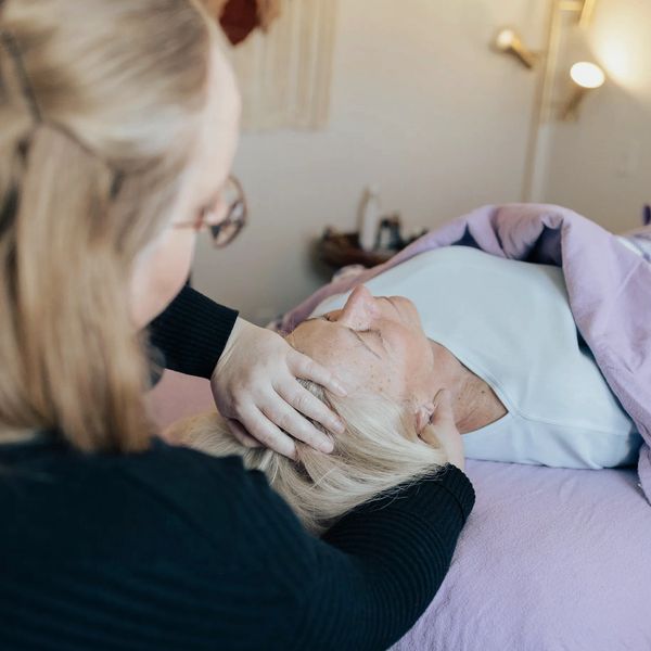 Holistic Health and Wellness Practitioner helps client on massage table: Body Alignments, Myofascial