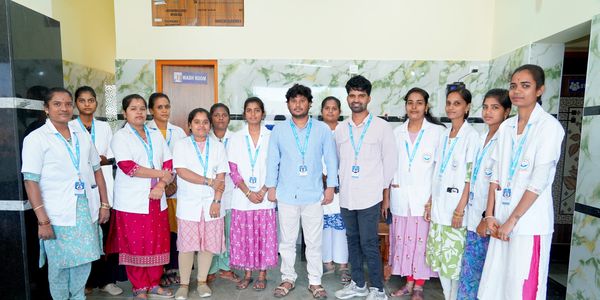 Group of healthcare workers posing indoors.