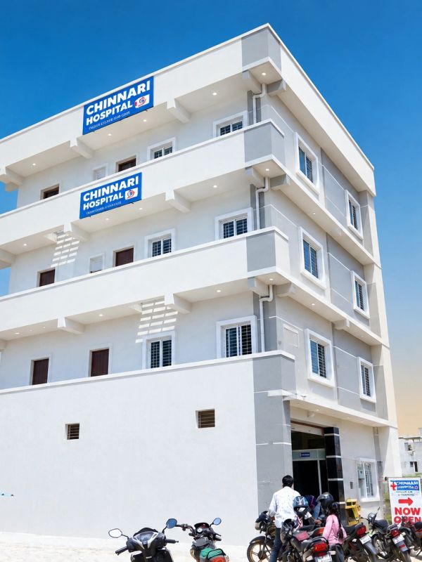 Modern Chinnari Hospital building with clear blue sky.