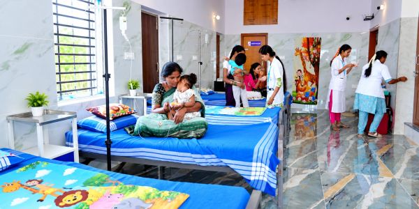 Children and mothers in a pediatric hospital ward.