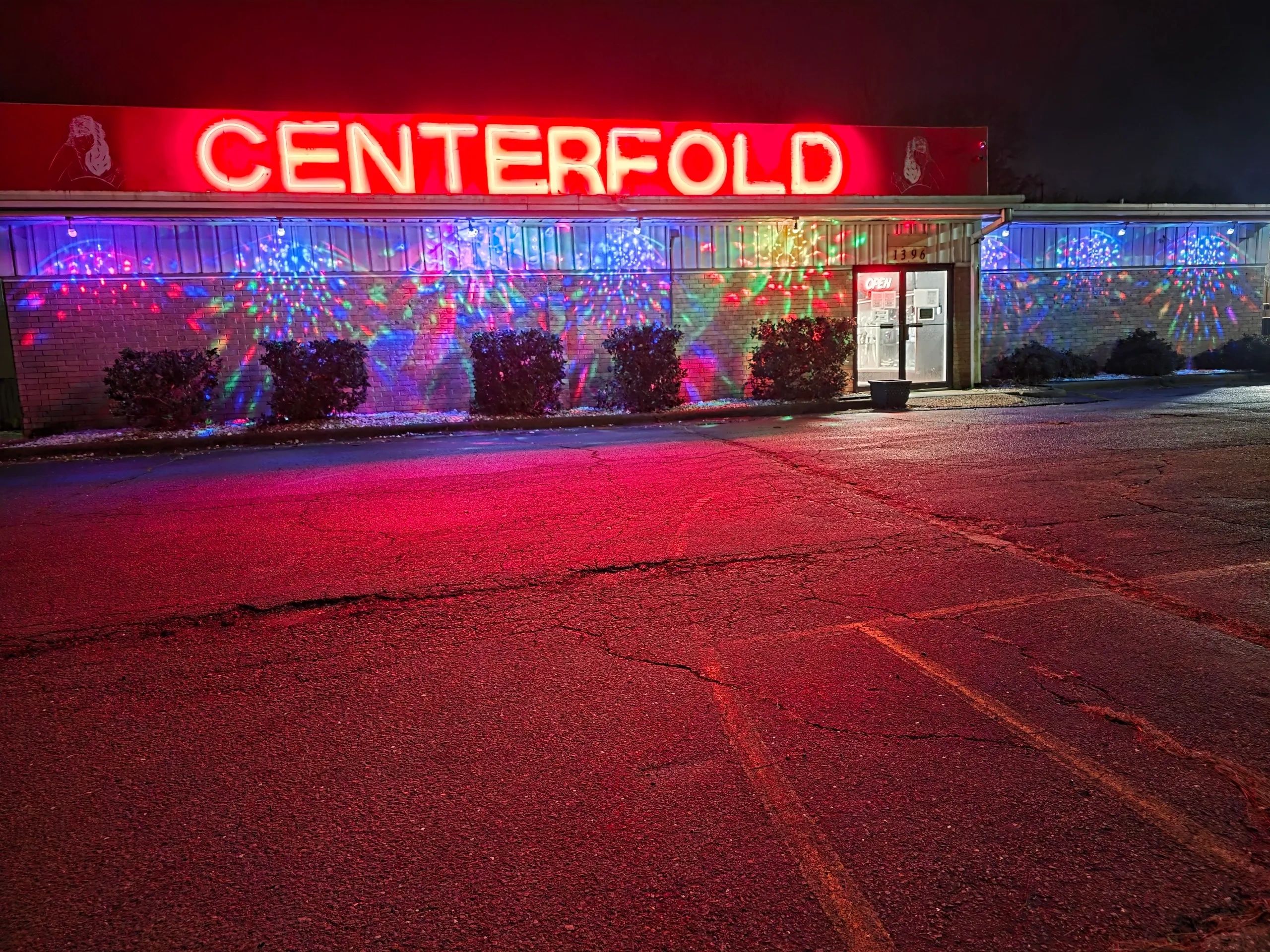Neon-lit building with colorful lights and a 'CENTERFOLD' sign.