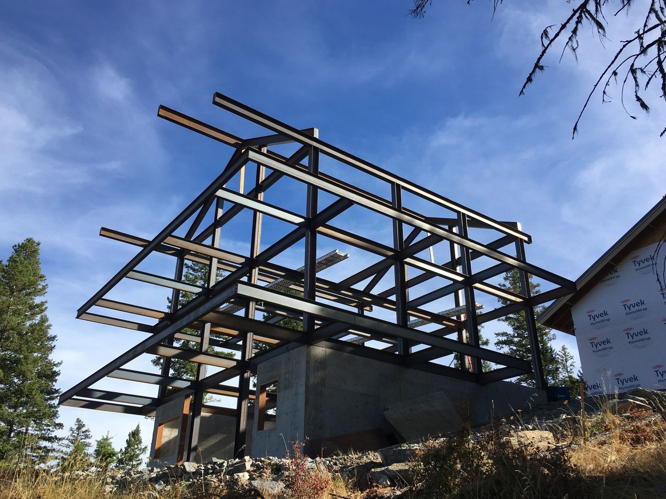 Stack of books next to pencils in a holder and a camera.
