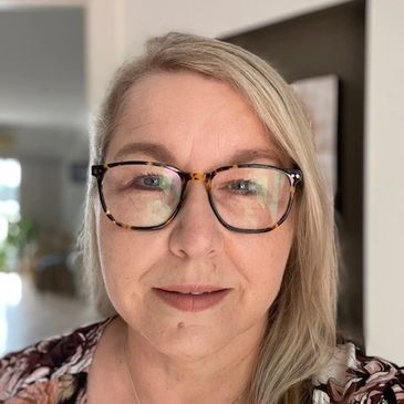 Woman with glasses and blonde hair.