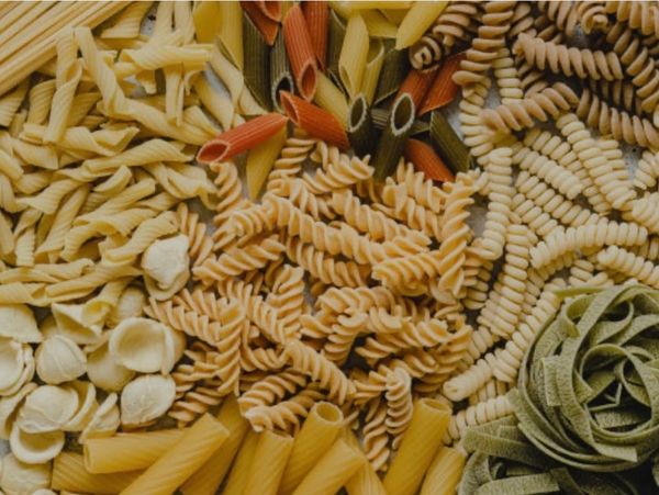 Various types of uncooked pasta arranged together.