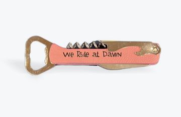 Pocket Corkscrew Bottle Opener. Shown in pink with black lettering "We Ride at Dawn"